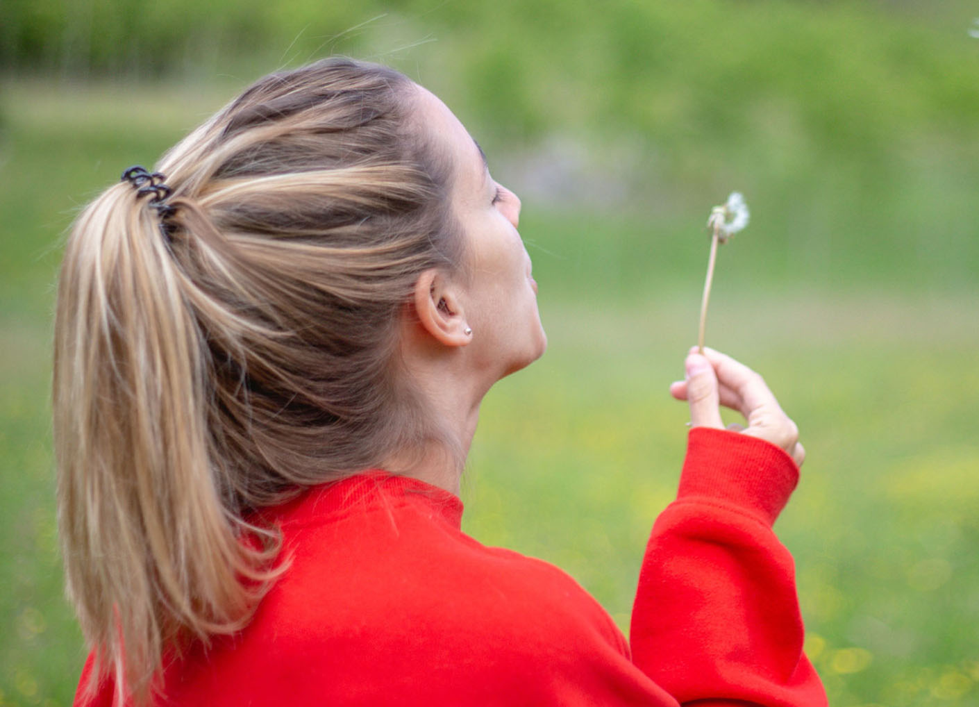 Girl blowing flower