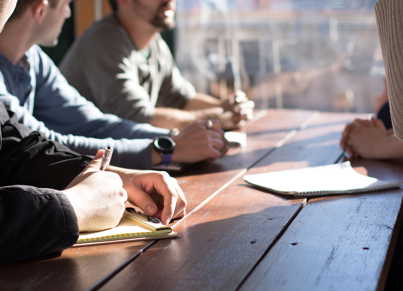 Workers sitting at meeting table